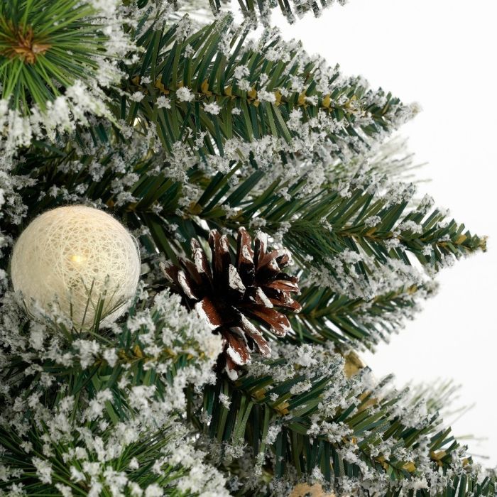 Juletræets grene med lysbold og kogle som dekoration