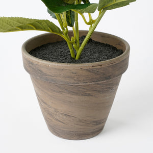 Grå lerpotte med kunstig hortensia i