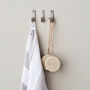 Meraki Knager i børstet stål med sølvfinish hængende på væg med håndklæde og sæbe