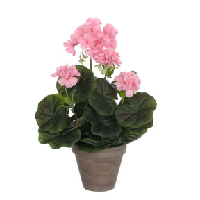 Kunstig lyserød pelargonie i grå potteskjuler