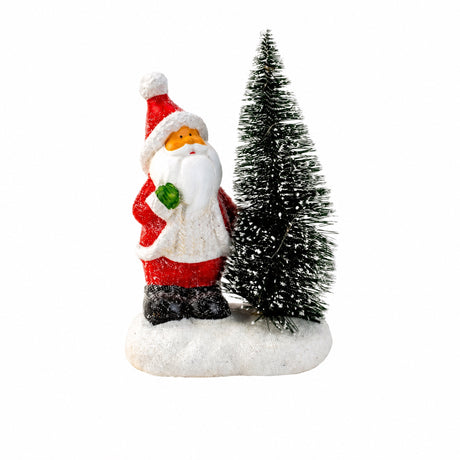 Jultomte eller snögubbe bredvid julgran med ljus