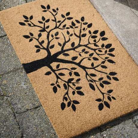 Ib Laursen dørmåtte i kokos med Livets træ liggende på fliser